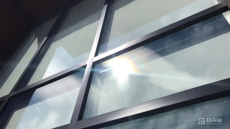 Close-up photo of a detail of the joint of the finish of an aluminum window painted in black.