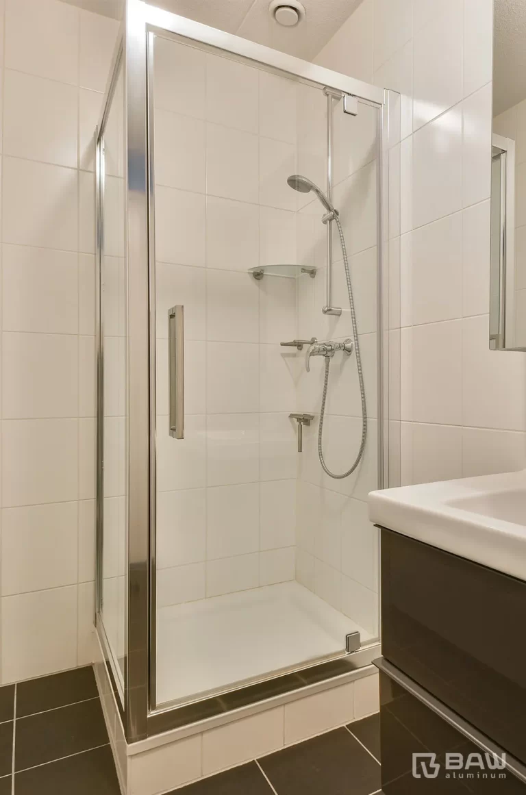 Bathroom with shower area with glass door and chrome frame